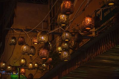 Low angle view of illuminated lanterns hanging at night