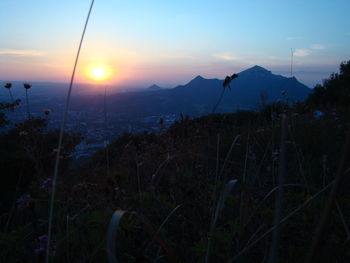 Scenic view of land against sky during sunset