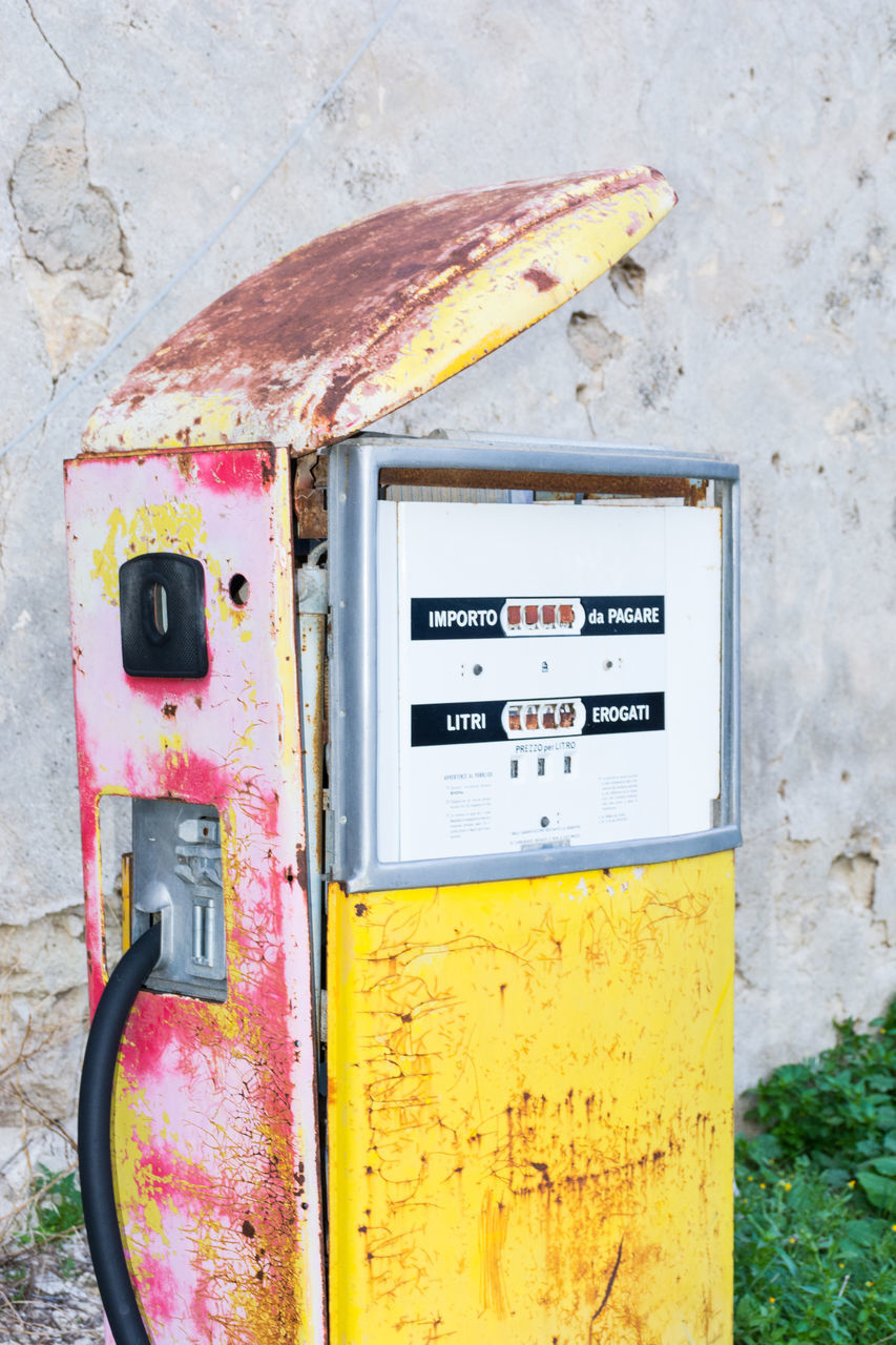 CLOSE-UP OF YELLOW RUSTY ABANDONED