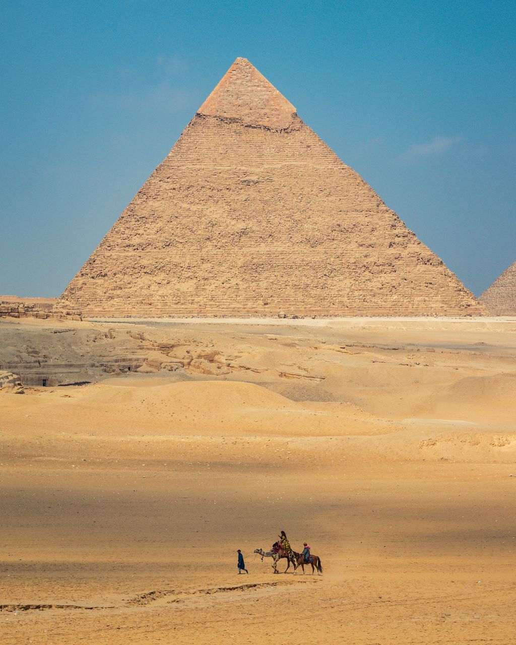 PEOPLE RIDING HORSE ON DESERT