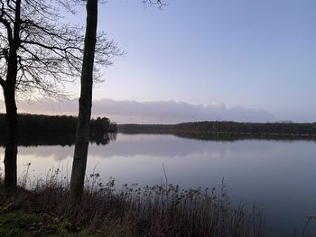 Scenic view of lake against sky at sunset