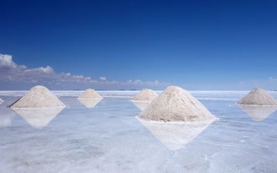 Scenic view of beach against blue sky