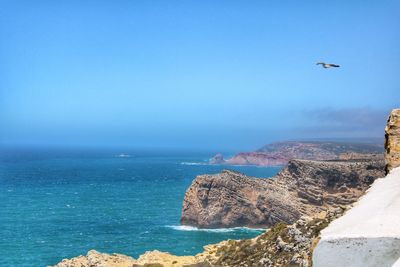 Scenic view of sea against clear blue sky