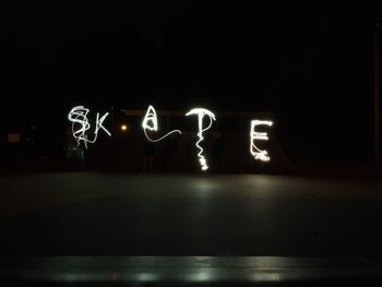 Illuminated light painting on wall at night