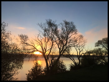 Scenic view of lake at sunset