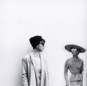 Young couple looking away against white background