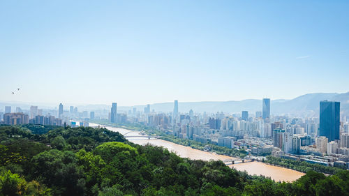 Buildings in city against clear sky
