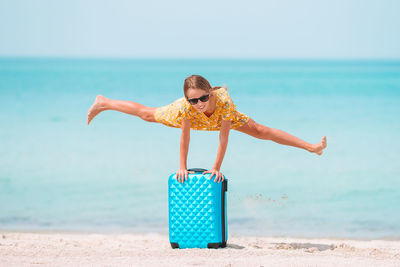 Girl doing split in air at beach