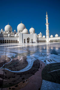 Low angle view of sheikh zayed mosque against blue sky