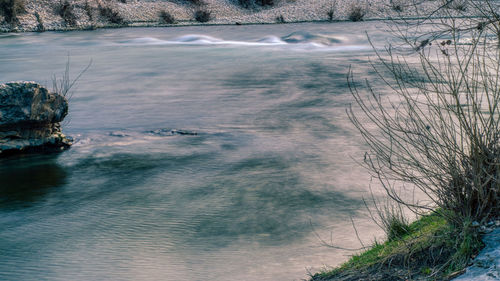 Scenic view of river amidst trees during winter