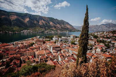 Aerial view of townscape by lake against sky