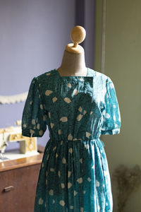 Green summer dress in mannequin.