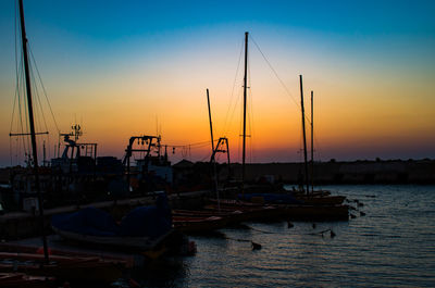 Boats in marina at sunset