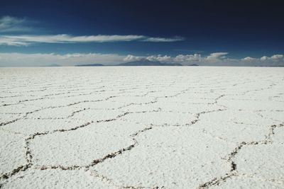 Scenic view of salt flat at salar de uyuni against sky