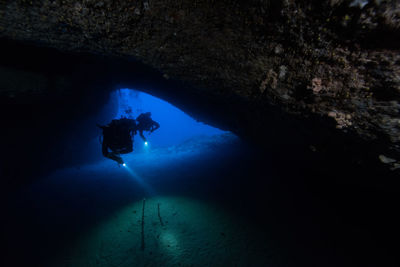 Silhouette of man in sea