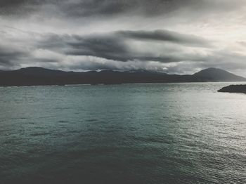 Scenic view of lake against cloudy sky