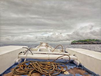 Fishing net on beach against sky