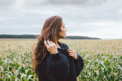 Young woman with long hair standing on landscape