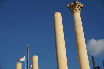 Low angle view of smoke stack against blue sky