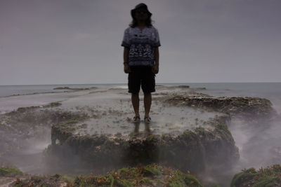 Rear view of man standing on beach