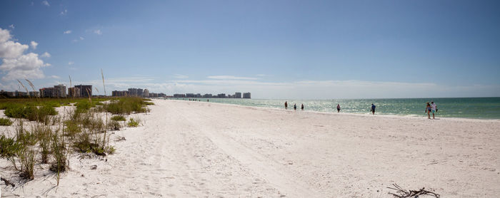 People on beach against sky