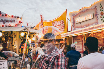 PEOPLE AT AMUSEMENT PARK IN CITY