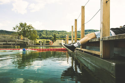 Girl standing on footbridge over river