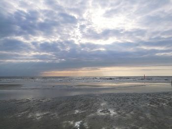 Scenic view of beach against sky during sunset