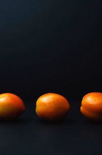 Close-up of tomatoes against black background