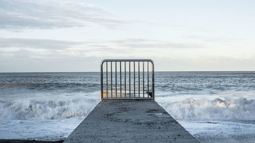 Lifeguard hut on beach against sky