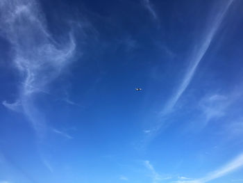 Low angle view of airplane flying in sky