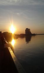 Scenic view of river at sunset