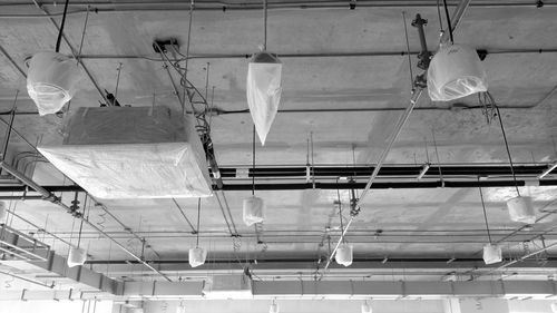 Low angle view of illuminated lights hanging on ceiling in building