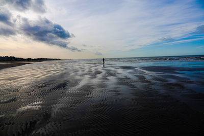 Scenic view of beach against sky during sunset