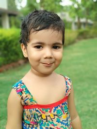 Portrait of cute girl standing on field