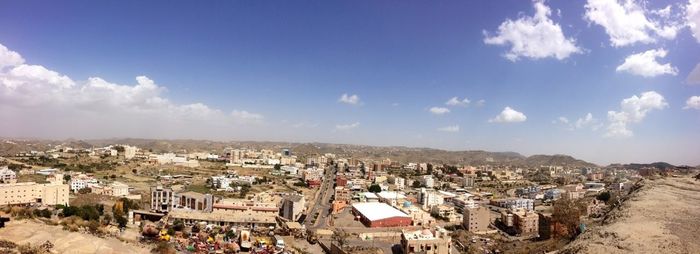 Cityscape against cloudy sky