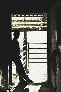 Side view of man standing in corridor