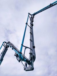 Low angle view of machinery against sky