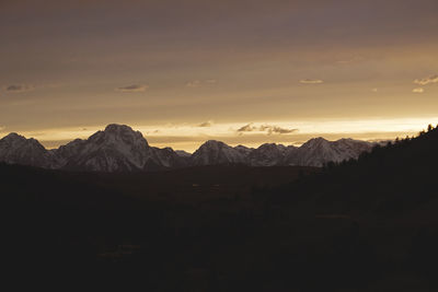 Scenic view of silhouette mountains against sky at sunset