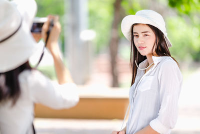 Portrait of woman wearing hat standing outdoors