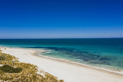 Scenic view of sea against clear blue sky