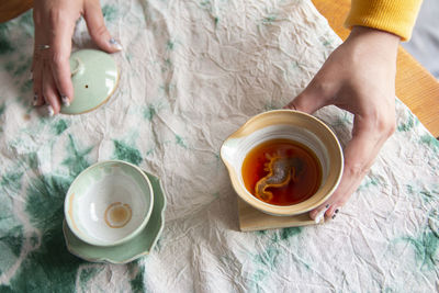 High angle view of woman serving tea