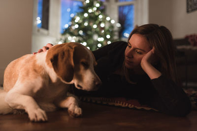 Close-up of a dog and woman relaxing at home