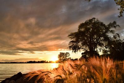 Scenic view of lake against sky during sunset