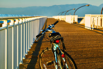 Bicycle at the pier during sunrise