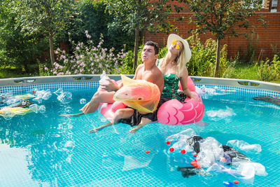 Woman sitting in swimming pool