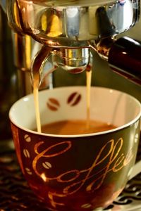 Close-up of coffee pouring in glass