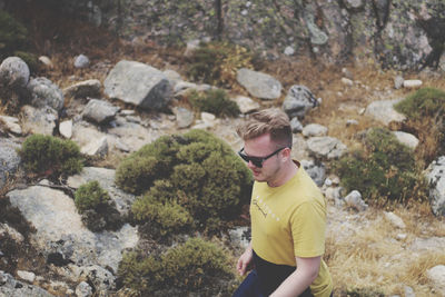 Young man standing on rock