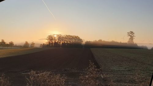 Scenic view of field against sky during sunset
