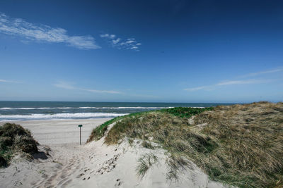 View of beach against blue sky